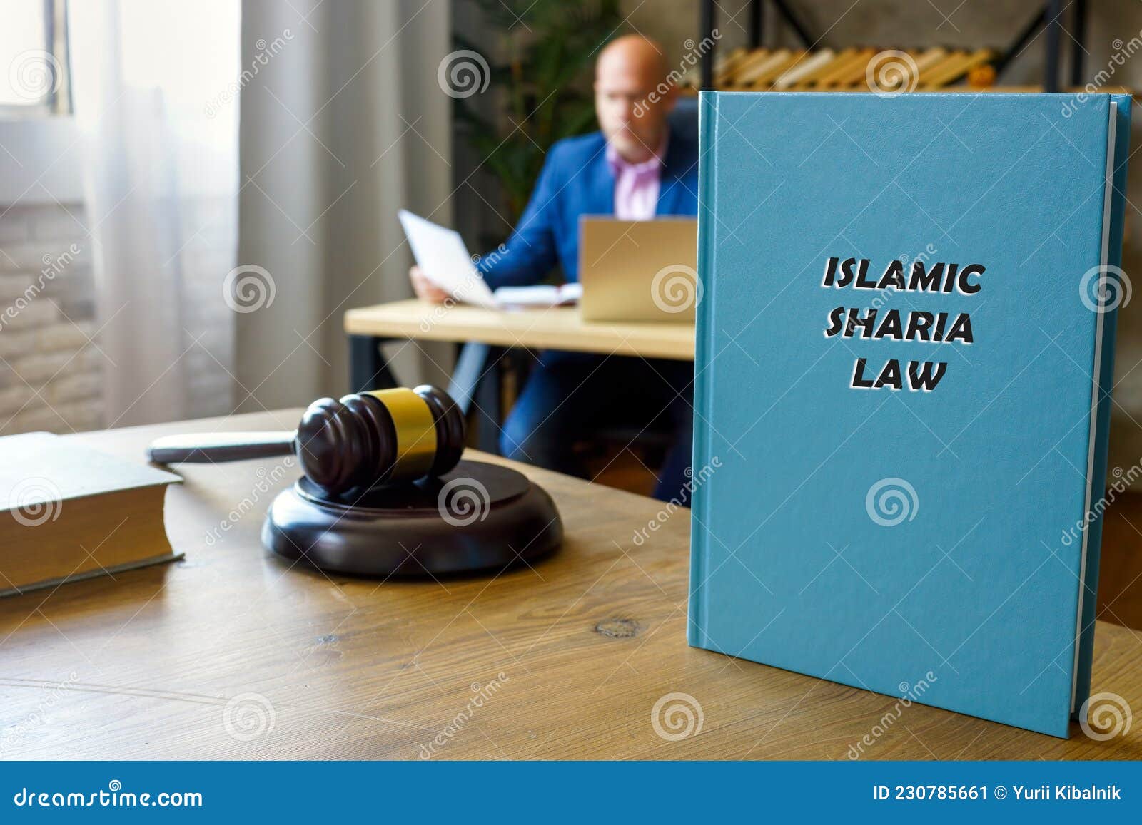 attorney holds islamic sharia law book. sharia lawÃÂ isÃÂ islam`sÃÂ legal system. it is derived from bothÃÂ theÃÂ koran